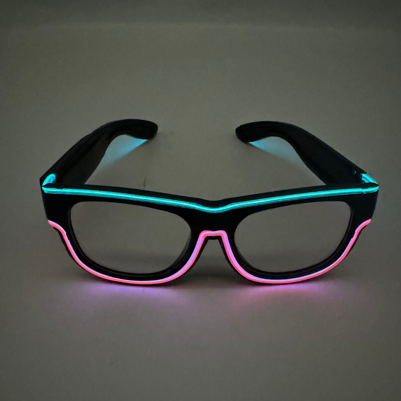 EL dual-colour shutter glasses lit in purple and orange on a dark table